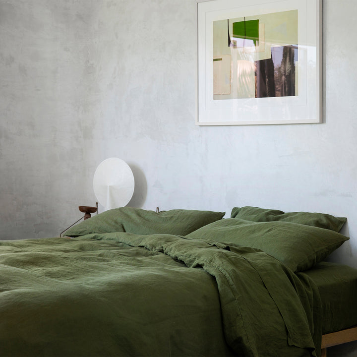 A bed dressed in Forest bed linen, styled with modern artwork. Sizes: Queen, King
