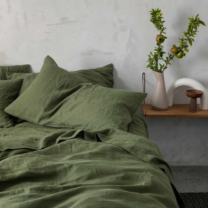 A bed dressed in Forest linen bedding