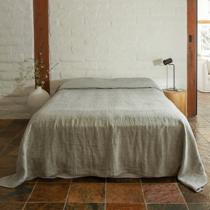A bed styled with the Chambray Heavyweight Bedcover in Black