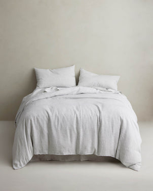 Linen duvet cover with pinstripe pattern by CULTIVER, styled on a bed with matching pillows and bedding for a cozy bedroom look.