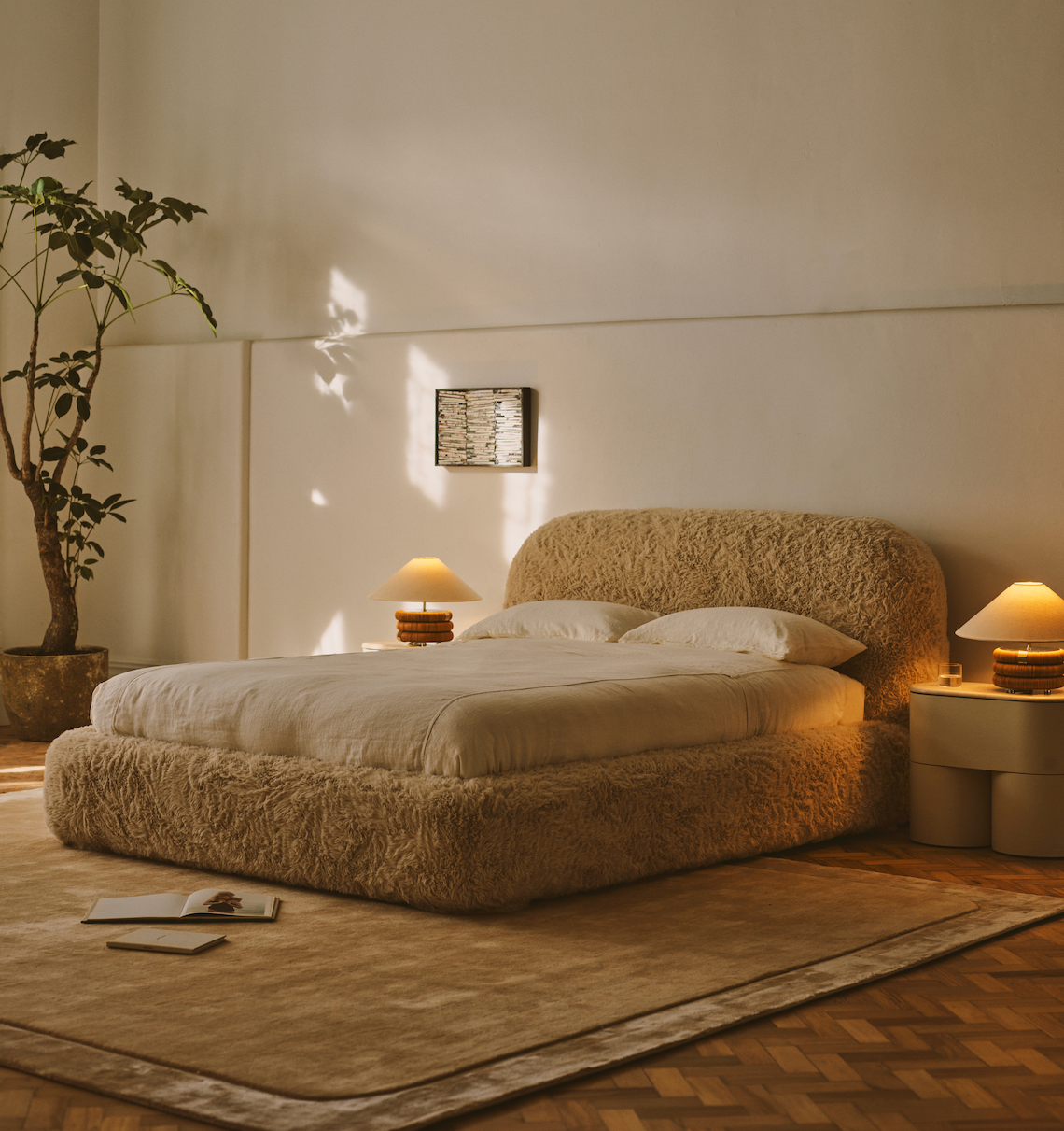 Cozy bedroom with a textured bed, nightstands, and wall lamp.