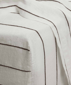 Close-up of white fabric with black stripes
