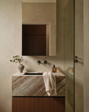 Light brown woven speckle cotton hand towel with fringed edges, from CULTIVER, displayed on a neutral background.