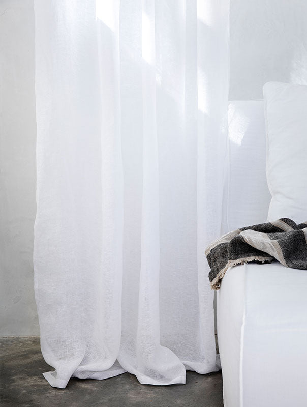 Beige bedding set with a pillow on a bed