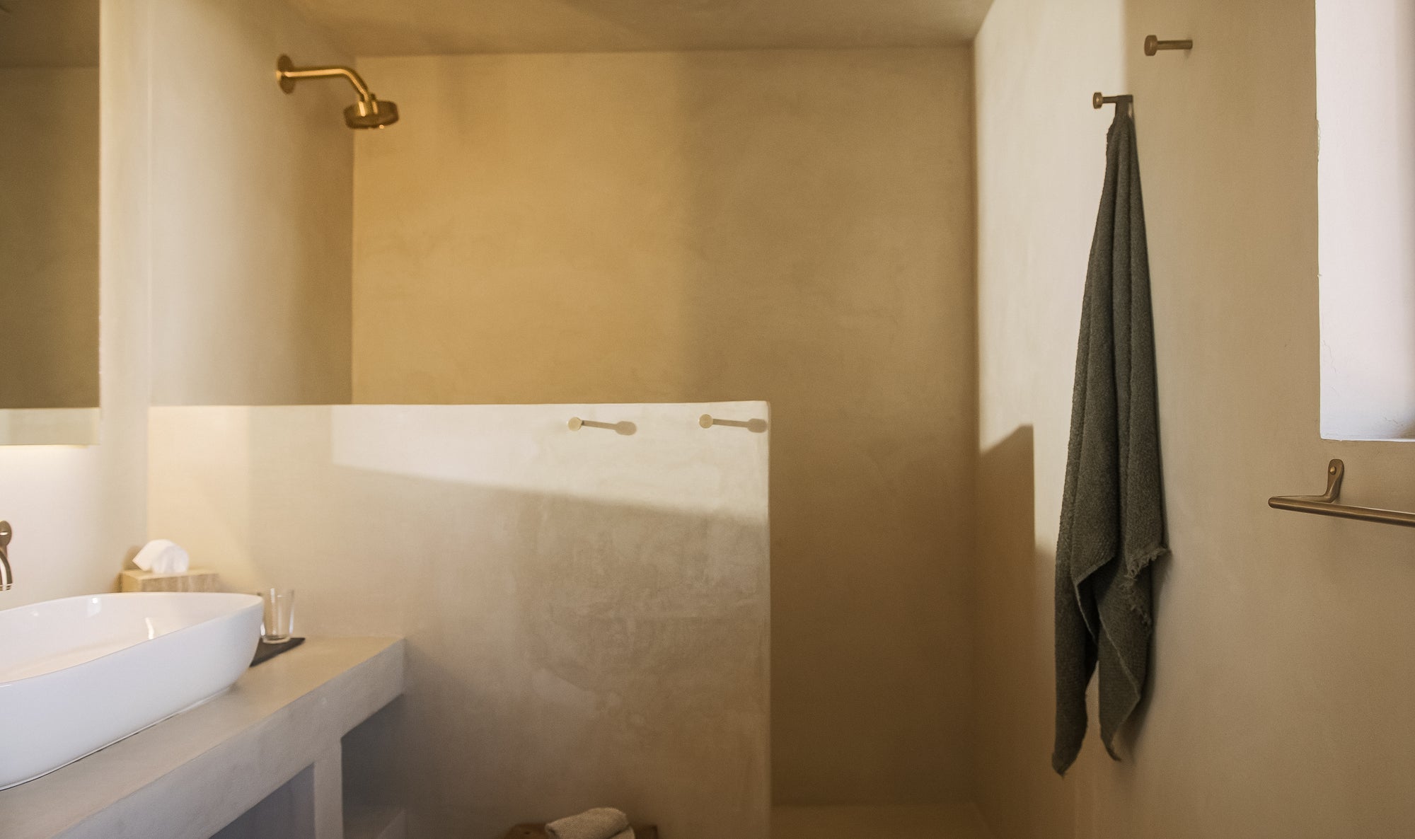 Bathroom interior with a sink, towel, and shower area.