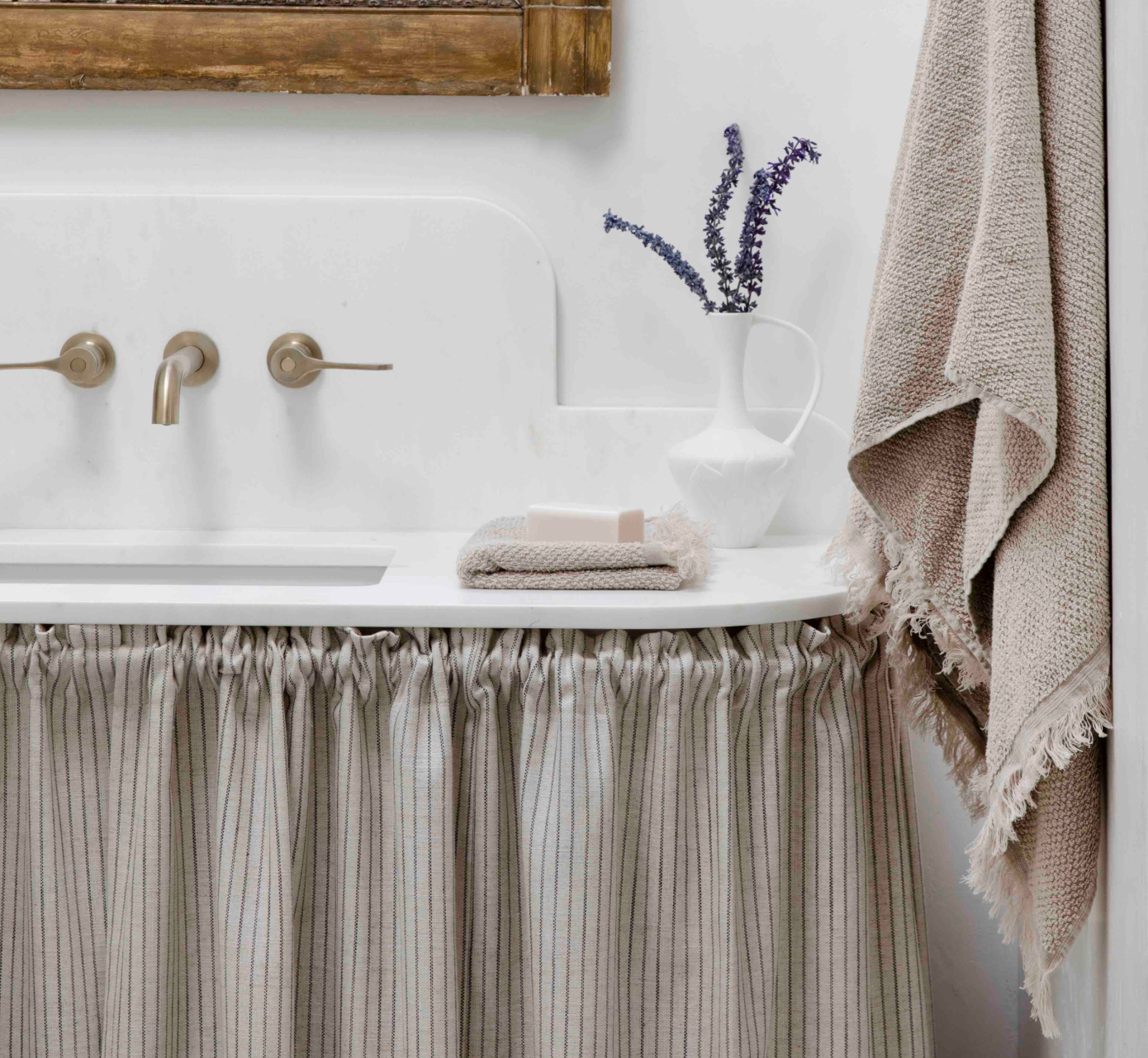Bathroom vanity with sink, towel, and decorative elements