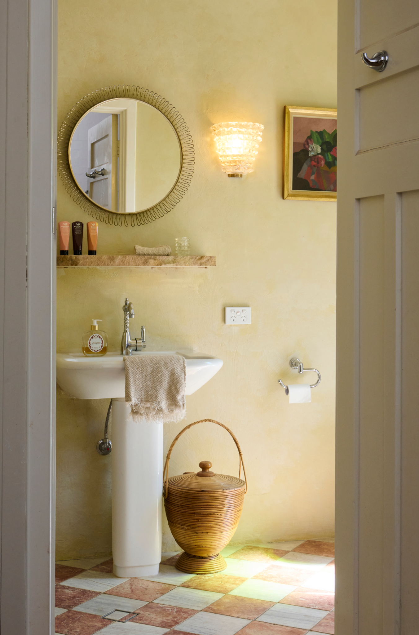 Bathroom interior with sink, mirror, and decorative elements.