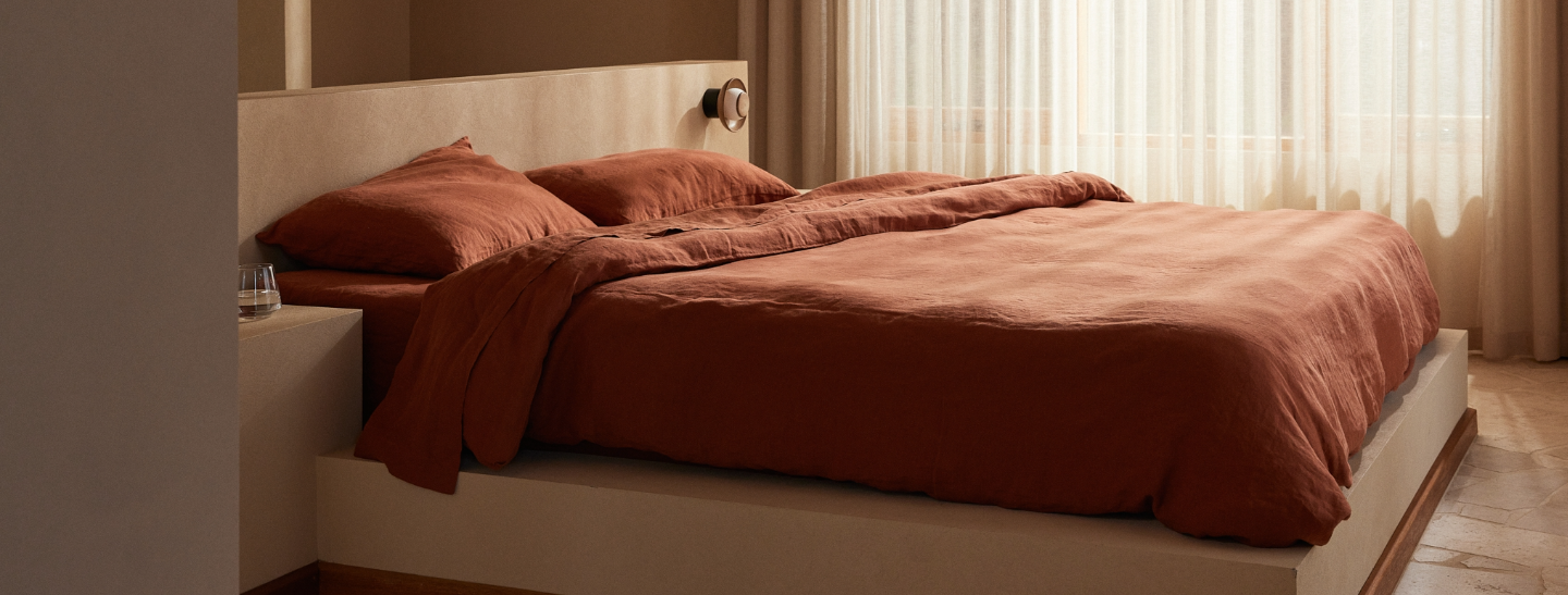 Bed with red bedding in a bedroom setting