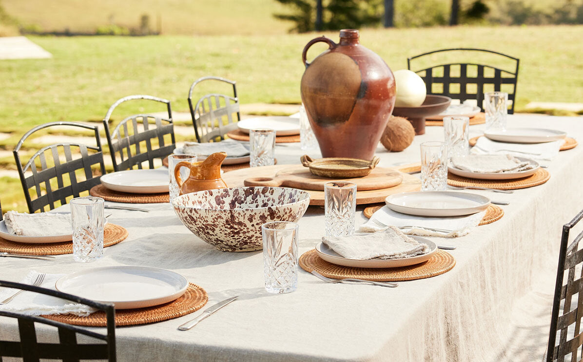 Dining table set with ceramicware and glasses outdoors