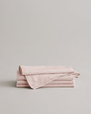 Stack of three blush linen table napkins by CULTIVER, showcasing soft, elegant fabric perfect for stylish dining settings.