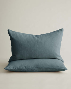 Two stacked blue linen pillowcases from CULTIVER's bed linen set, featuring soft, natural fabric and a sleek, modern design.