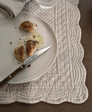 Plated food with a knife on a textured placemat