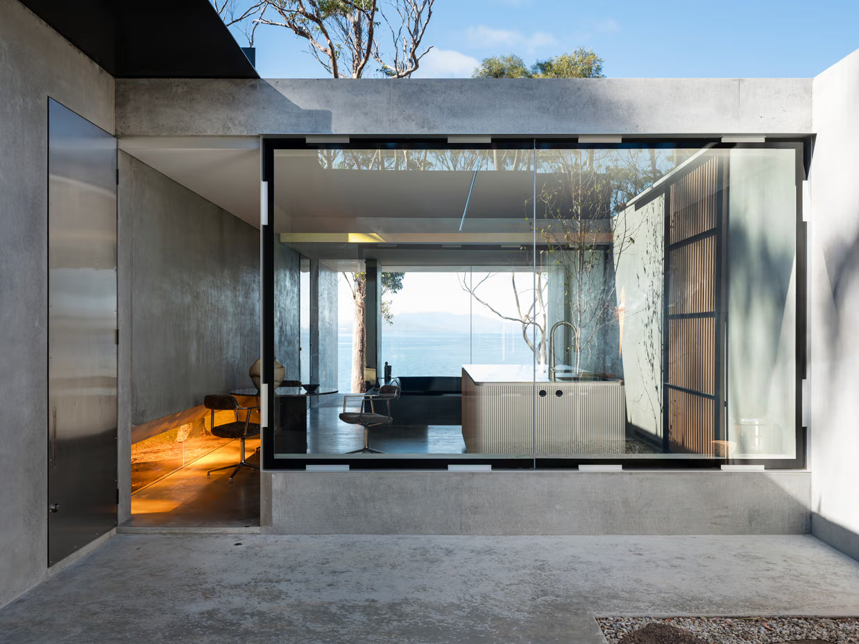 Modern interior with large glass doors leading to an outdoor area.