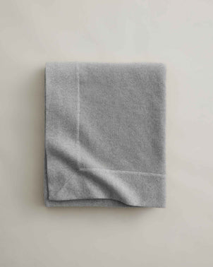Cultiver Alba Cashmere Throw in Fog color, neatly folded, showcasing soft, luxurious cashmere fabric perfect for cozy home decor.
