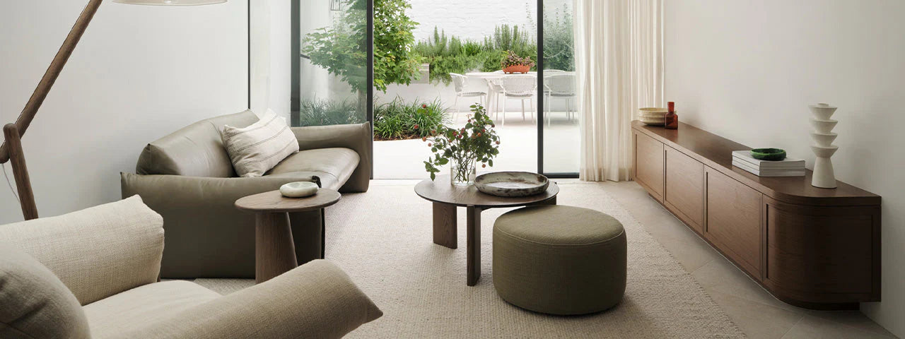 Modern living room with gray sofa, wooden coffee table, and decorative items.
