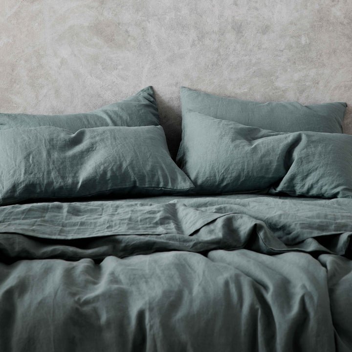 A cropped photo of a bed dressed in Bluestone bed linen. Sizes: Queen, King