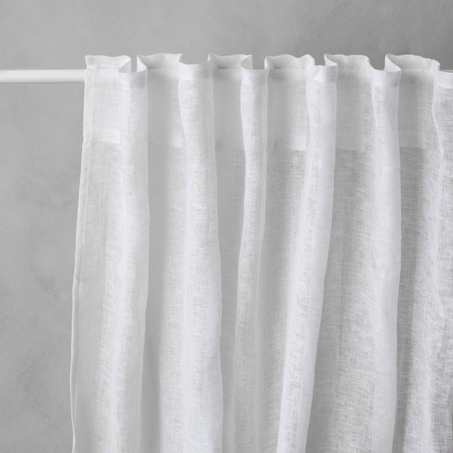 Linen Curtain - White hangs on railing