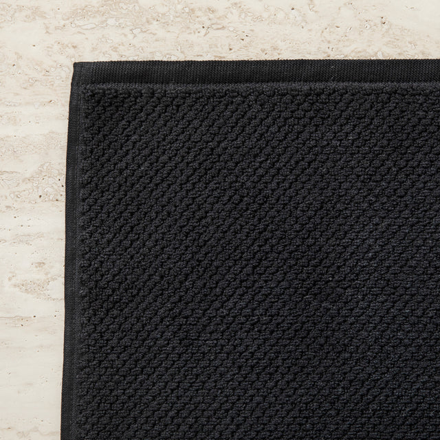  A close up of the corner of the Bath Mat in Black