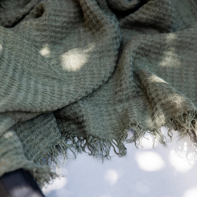A close up of an Estela Linen Waffle Throw in Forest
