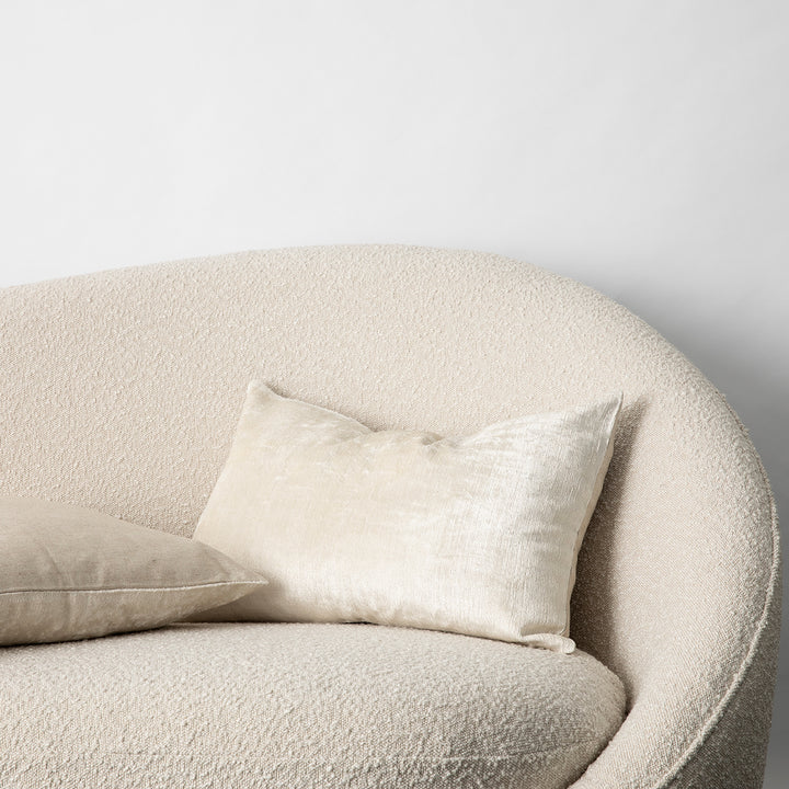 The Talik Velvet Cushion in Cream on a boucle lounge.