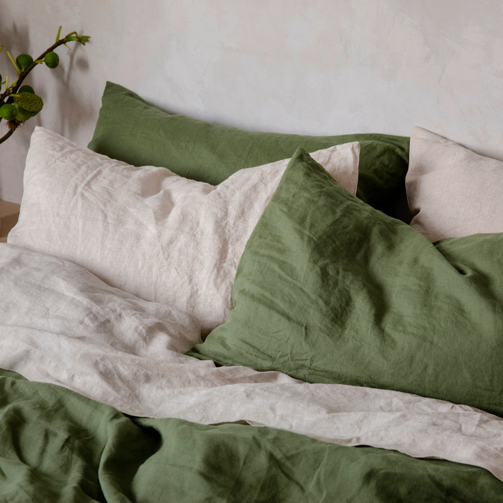 Close up of a bed dressed in Natural and Forest bedlinen.