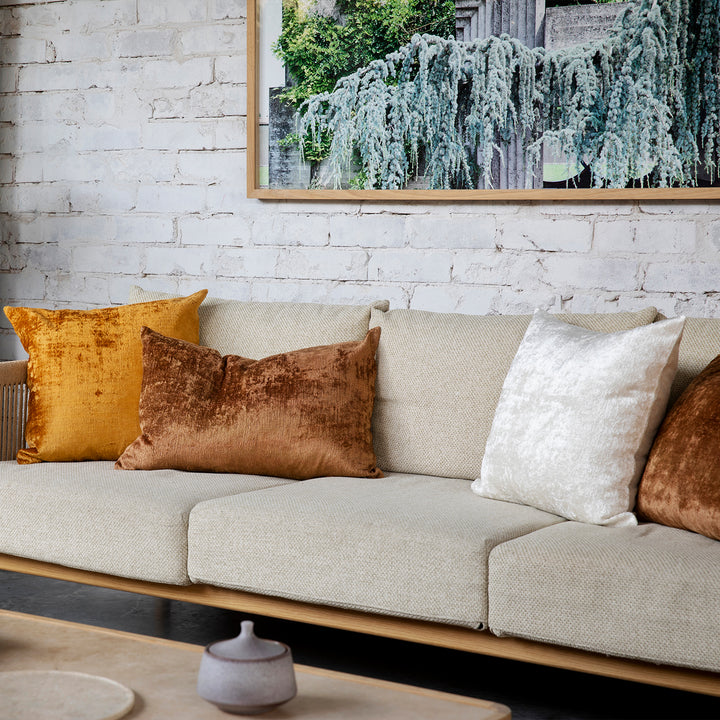 A sofa styled with Talik Velvet Cushions in Fawn, Cream and Mustard