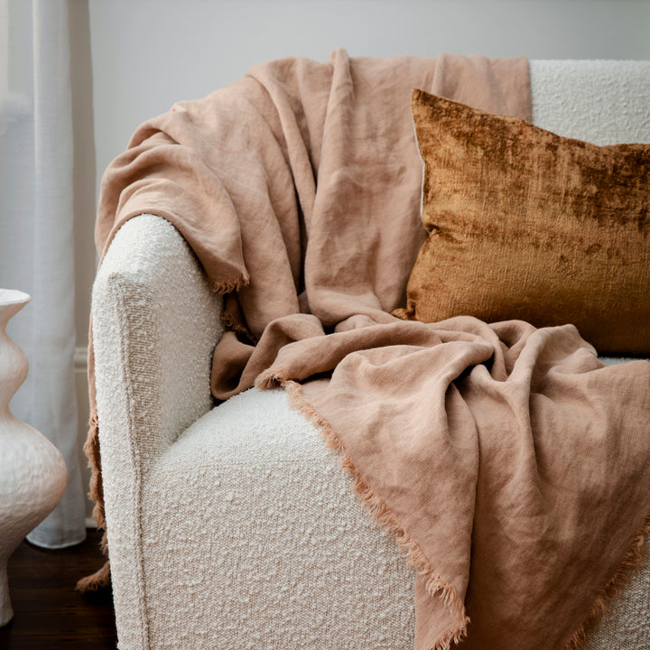 Talik Velvet Cushions in Fawn and a Freya Throw in Fawn, on a boucle lounge