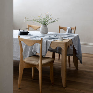 A table dressed with a Sky Linen Tablecloth
