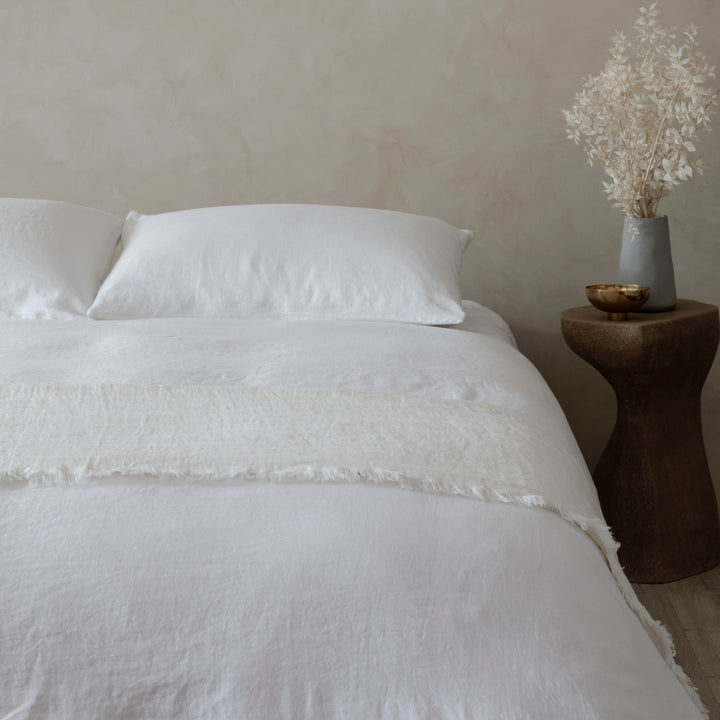 A bed dressed in White bed linen and a Freya Linen Throw in Snow. Sizes: Twin, Queen, King, California King