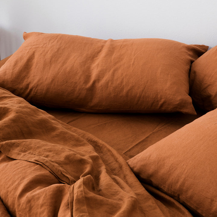 A close up of a bed styled dressed in Cedar bedlinen.