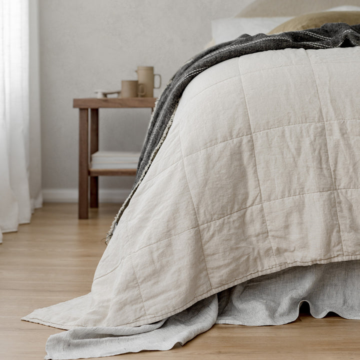  A Quilted Bedcover in Natural paired with Pinstripe and Olive bed linen, featuring a Mira Linen Throw in Rafa