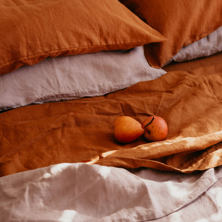 Close up of Cedar and Dusk bedlinen, styled with pears.