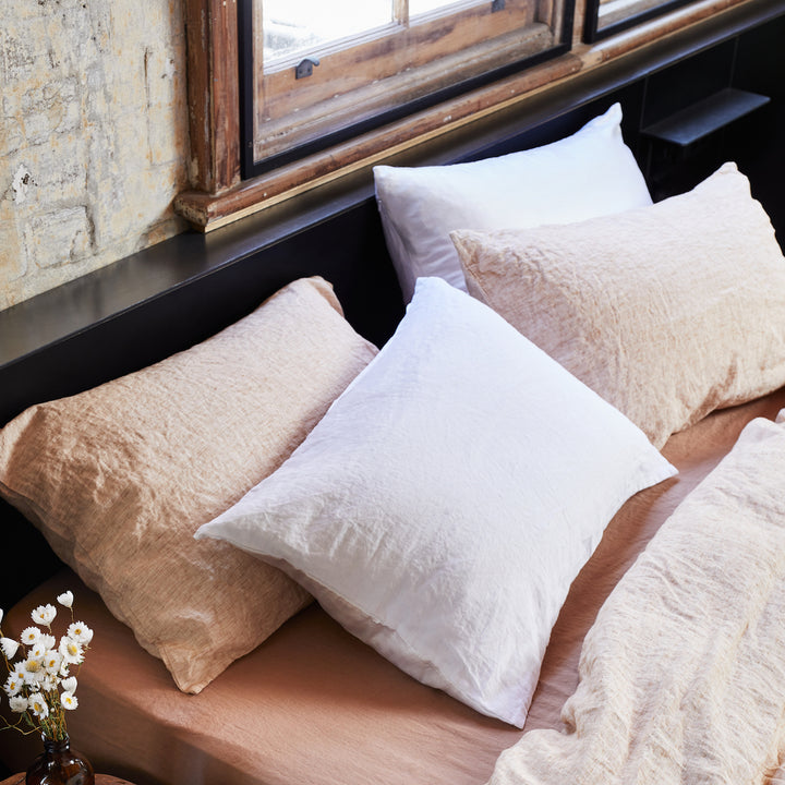 A bed dressed with White and Cinnamon Pillowcases, on a Fawn Fitted Sheet.
