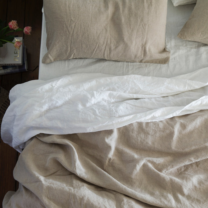 A bed dressed in Natural and White bed linen