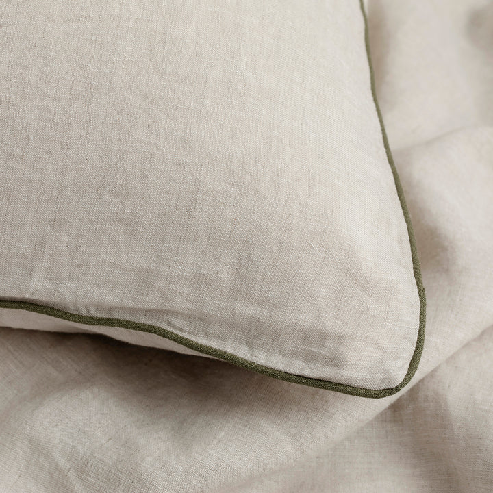 A close up of a Natural and Forest Piped Linen Pillowcase