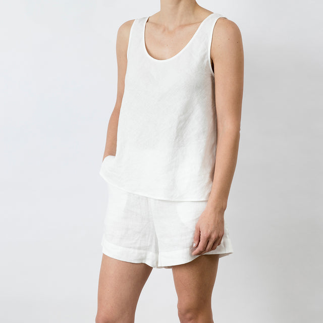 Side view of Piper Linen Singlet in White. Model is also wearing the matching Piper Linen Short in White.