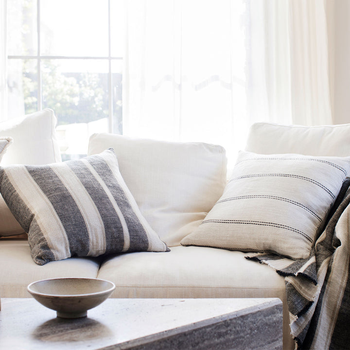 A cream sofa styled with the Mira Linen Cushion Covers in Enzo and Ana