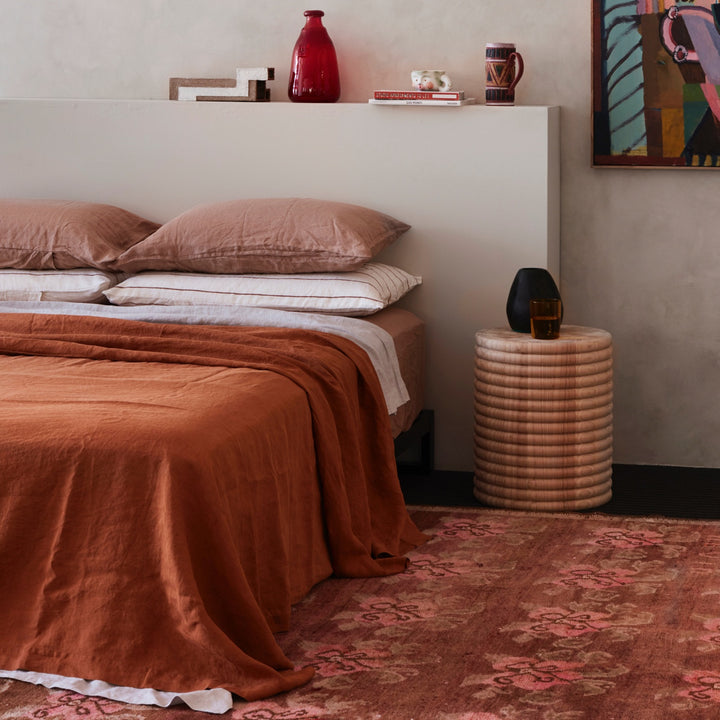  A bed dressed in Cedar, Smoke Grey, Fawn and Cedar Stripe bed linen